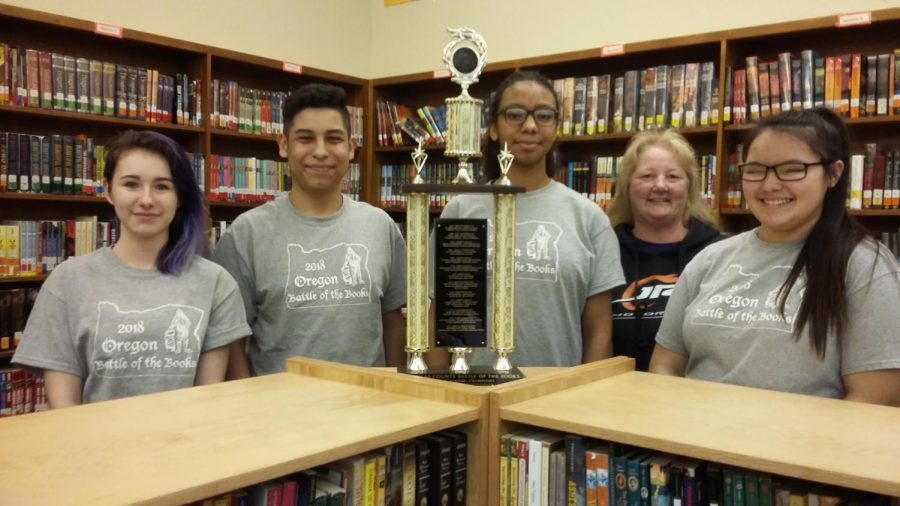 Jasmine Bailey, Israel Sierra, Adrianna Sapp, Teri Morrison (coach) and Savaun Deng pose with their trophy after winning the Battle of the Books regional competition for the second year in a row. 